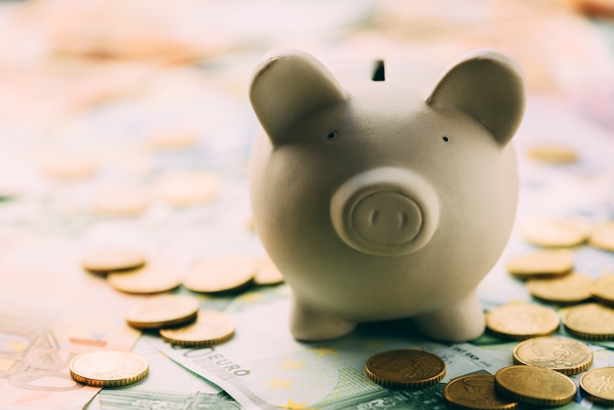 Piggy moneybox with euro cash and coins closeup. Financial concept