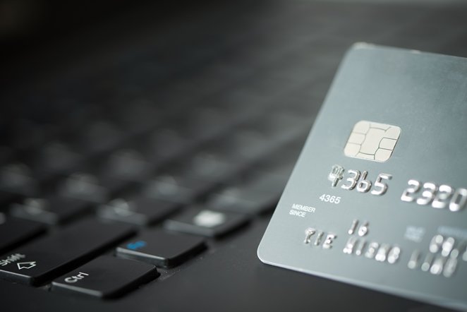 Credit card on laptop for online payment or shopping concept